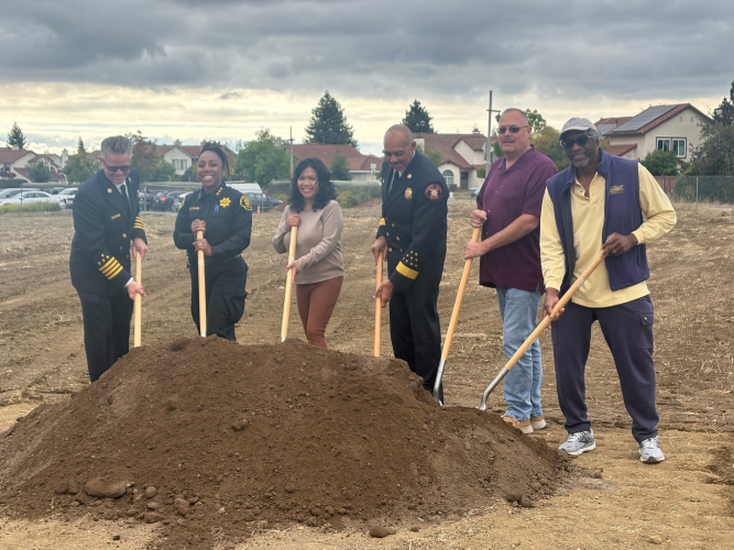 April Chan with uniformed fire officials and community members holding shovels at the groundbreaking for a new fire station in Castro Valley