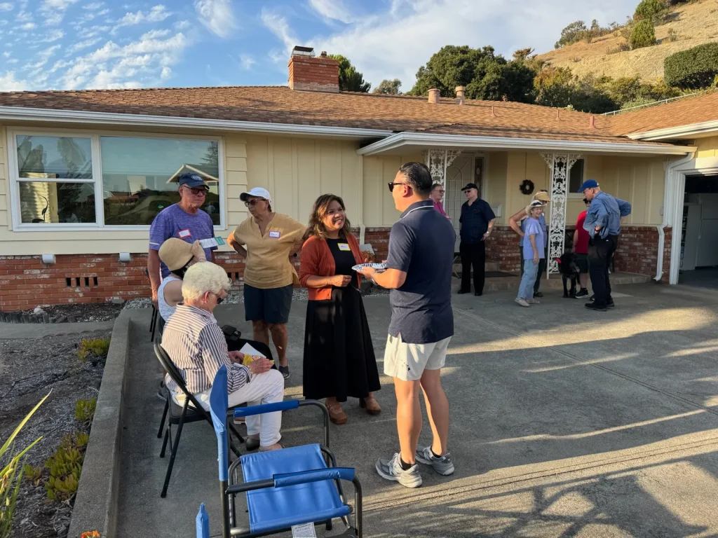 April Chan talks with a supporter while neighbors gather at a Bay-O-Vista meet and greet in San Leandro